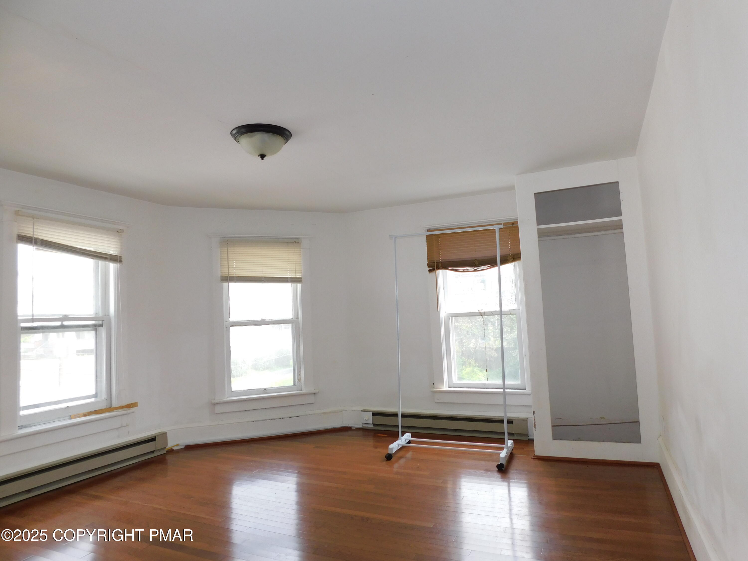 112 Ridgeway Street East Stroudsburg, PA 18301 - Photo 33 of 39 an empty room with wooden floor and windows