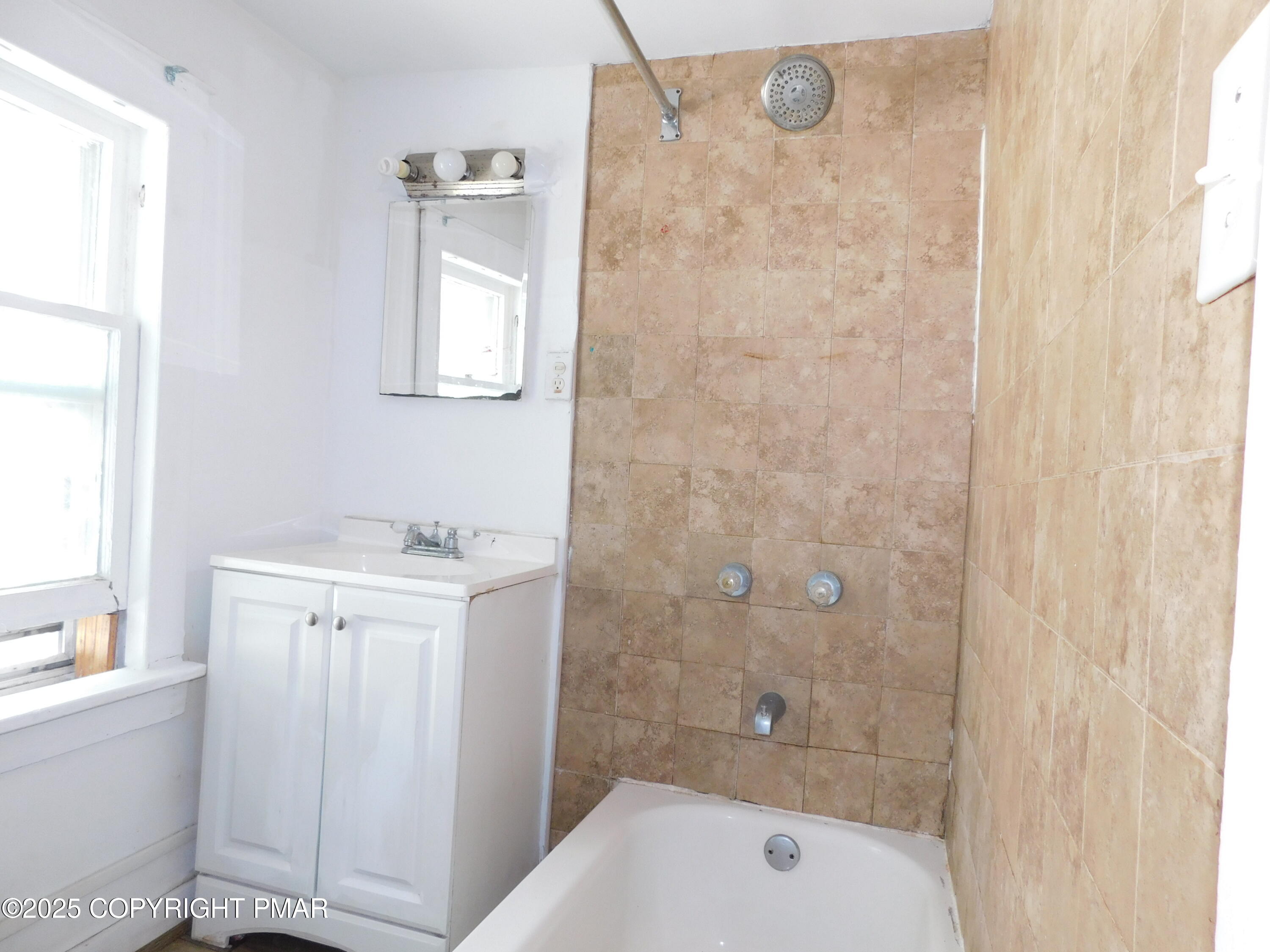 112 Ridgeway Street East Stroudsburg, PA 18301 - Photo 34 of 39 a bathroom with a granite countertop bathtub shower sink and mirror