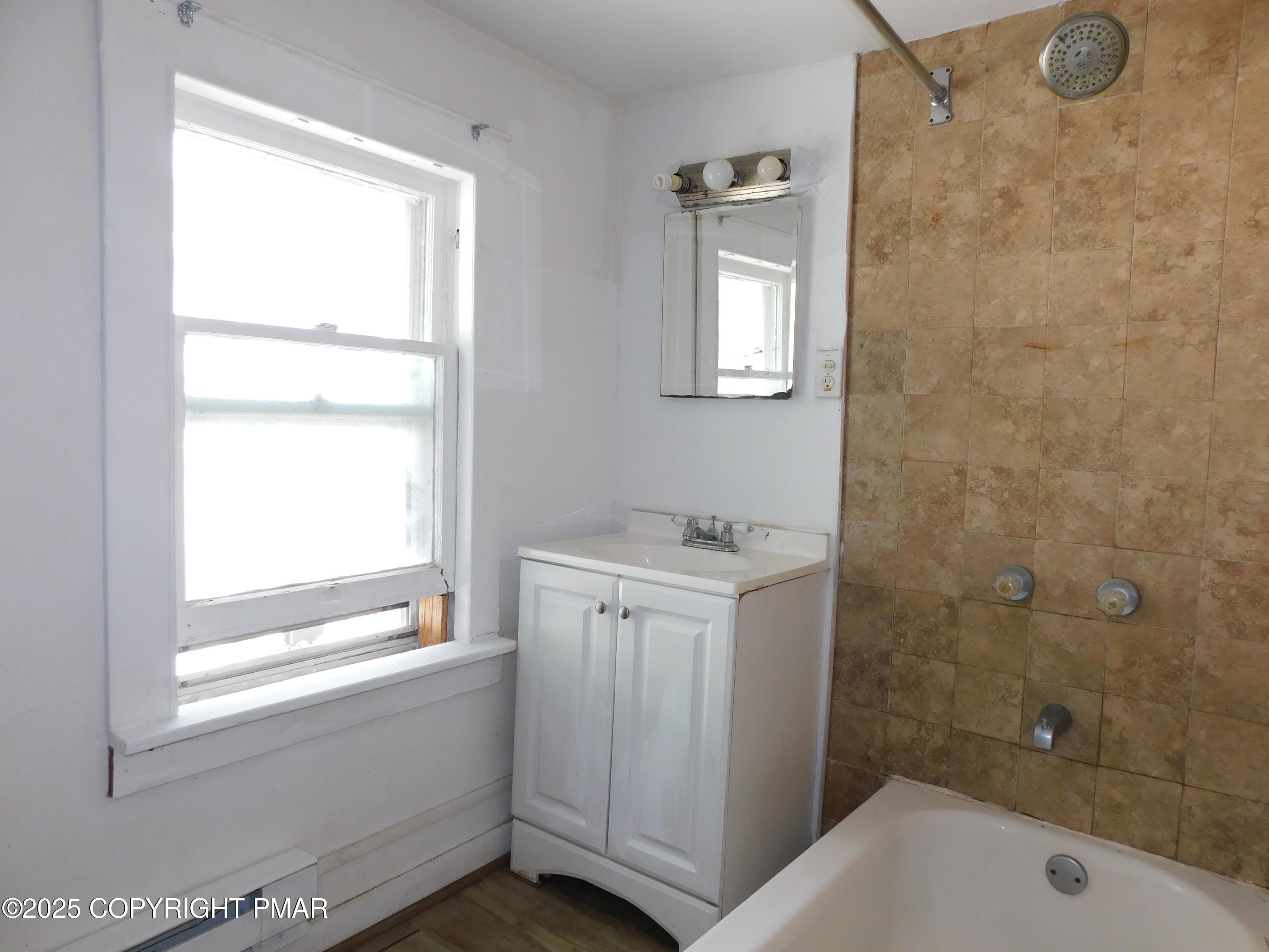 112 Ridgeway Street East Stroudsburg, PA 18301 - Photo 36 of 39 a bathroom with a granite countertop sink a toilet and shower