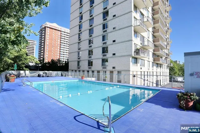 a view of a swimming pool with a lounge chair