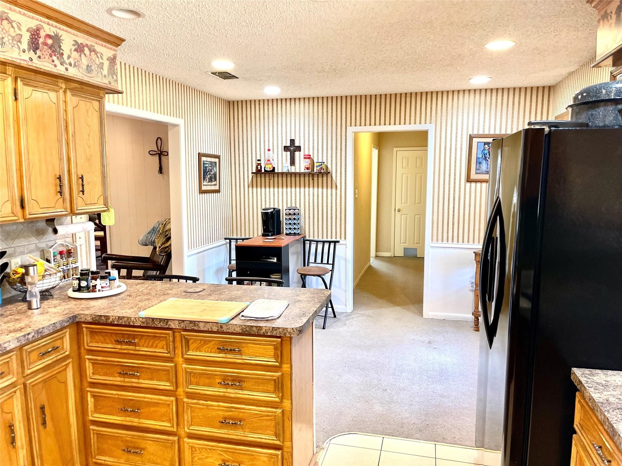 710 South Main Street Coolidge, TX 76635 - Photo 15 of 36 a view of a kitchen with a sink a refrigerator and a view of living room