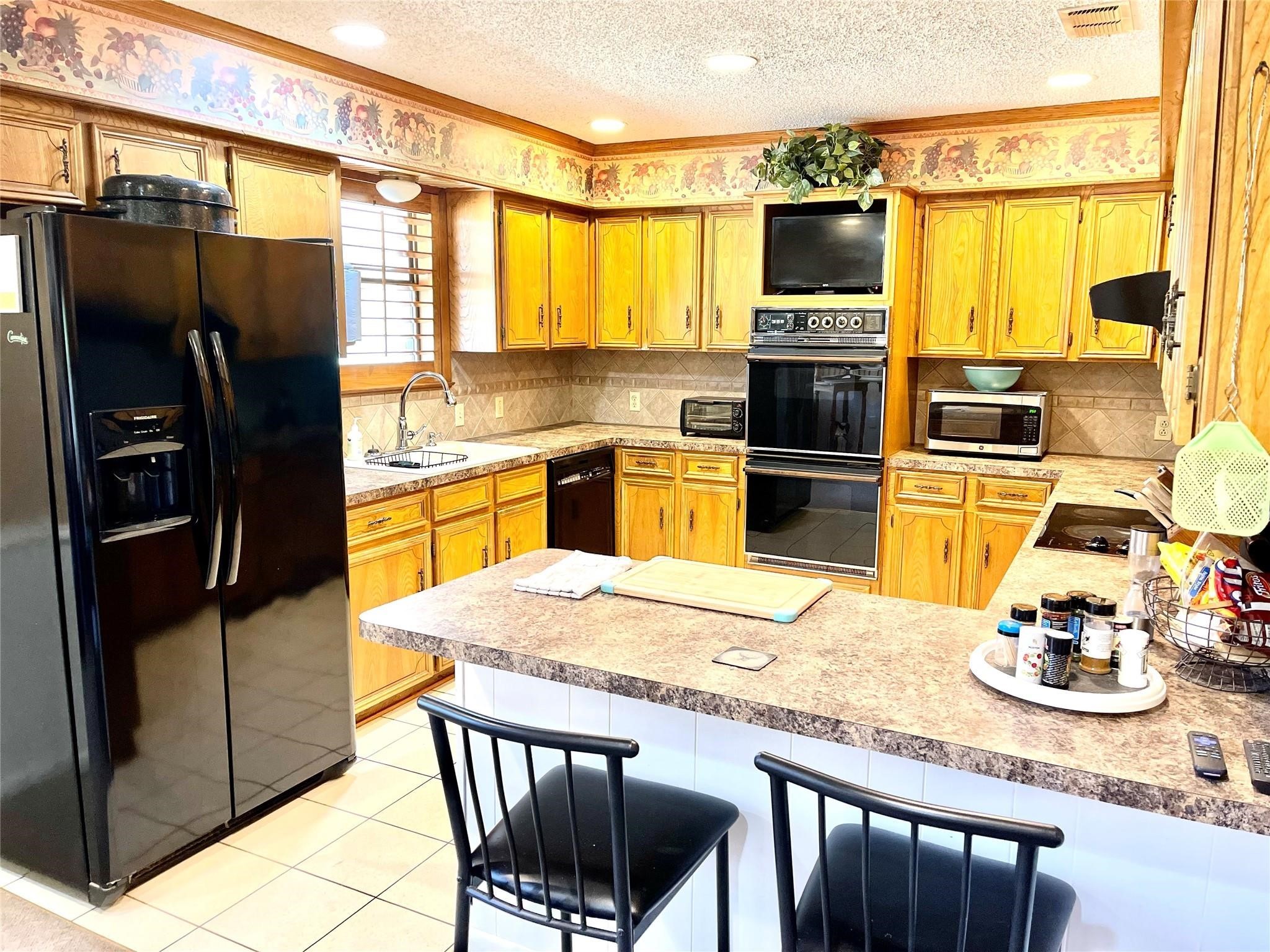 710 South Main Street Coolidge, TX 76635 - Photo 16 of 36 a kitchen with a refrigerator and a stove top oven