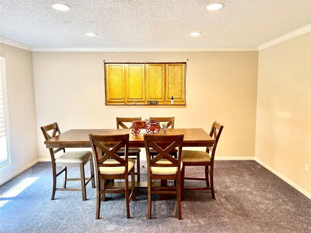 a view of a dining room with furniture and a window