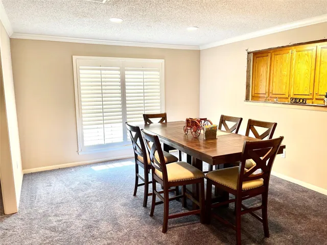 a view of a dining room with furniture and a window