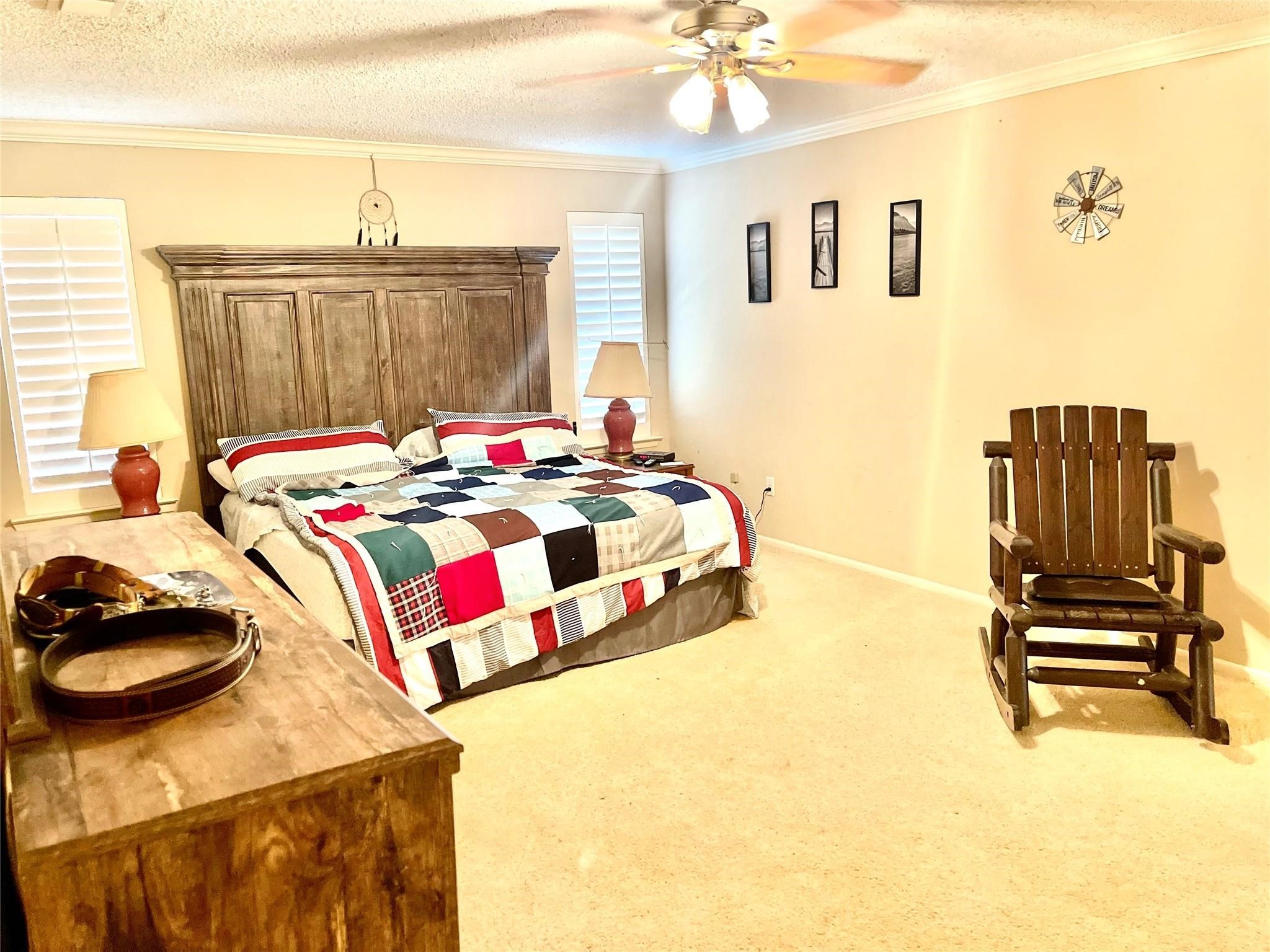 710 South Main Street Coolidge, TX 76635 - Photo 25 of 36 a bedroom with a bed and a chandelier