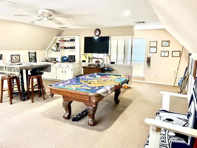 a living room with dining table and a flat screen tv
