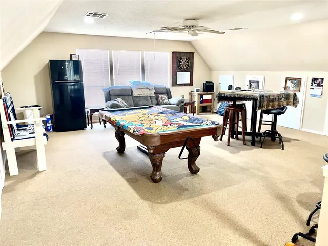 a living room with stainless steel appliances kitchen island granite countertop furniture and a kitchen view