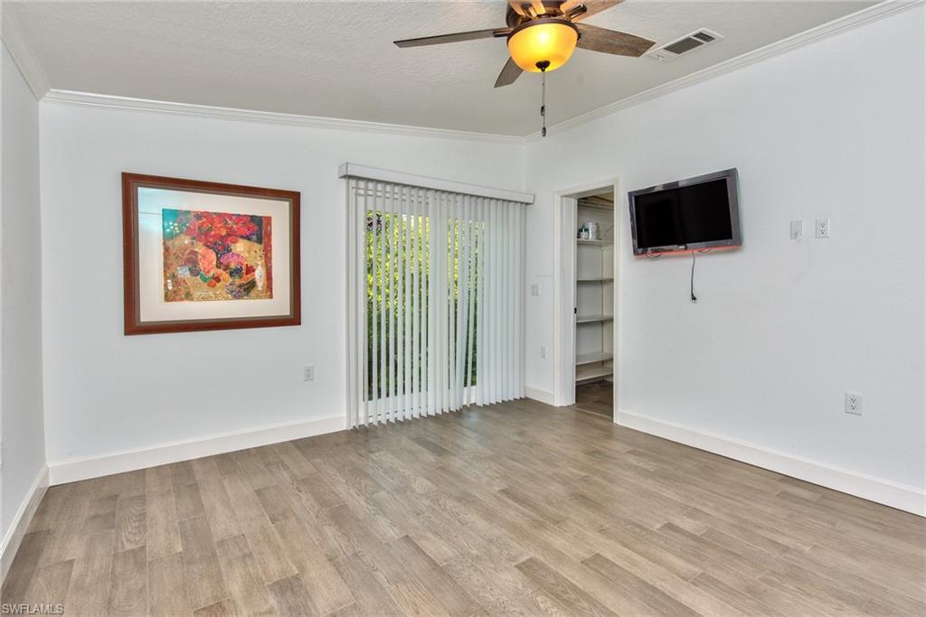 777 Walkerbilt Road, Unit 27 Naples, FL 34110 - Photo 30 of 31 wooden floor in an empty room with a window