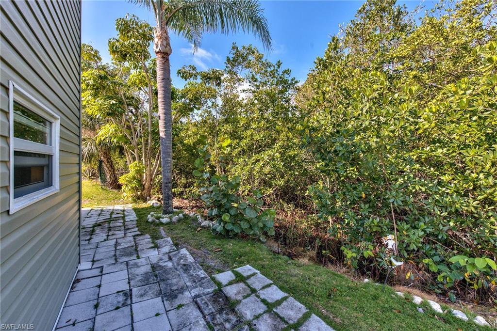 777 Walkerbilt Road, Unit 27 Naples, FL 34110 - Photo 5 of 31 a view of a yard with plants