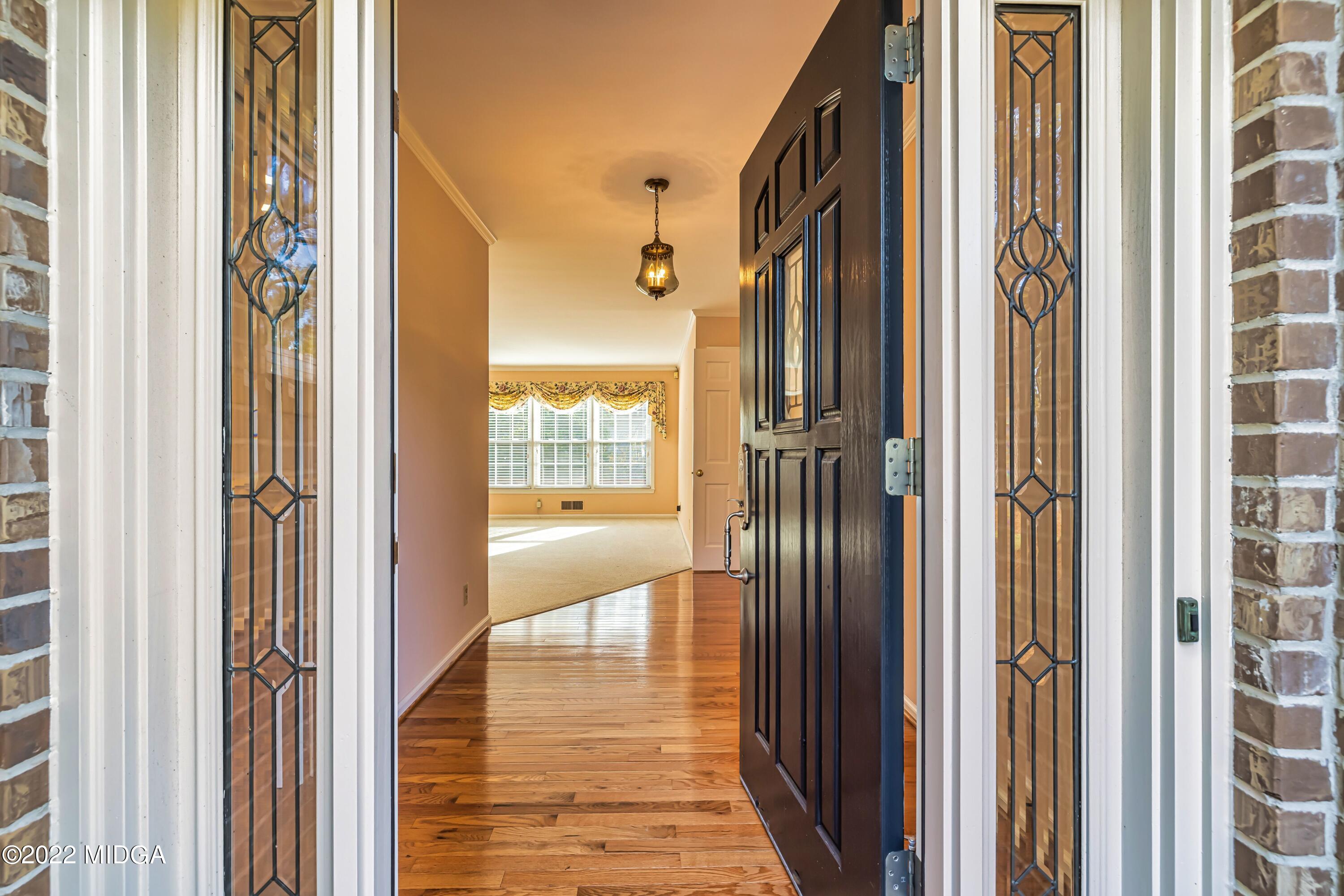 201 Larcom Lane Griffin, GA 30224 - Photo 12 of 64 a view of a hallway with wooden floor and glass door