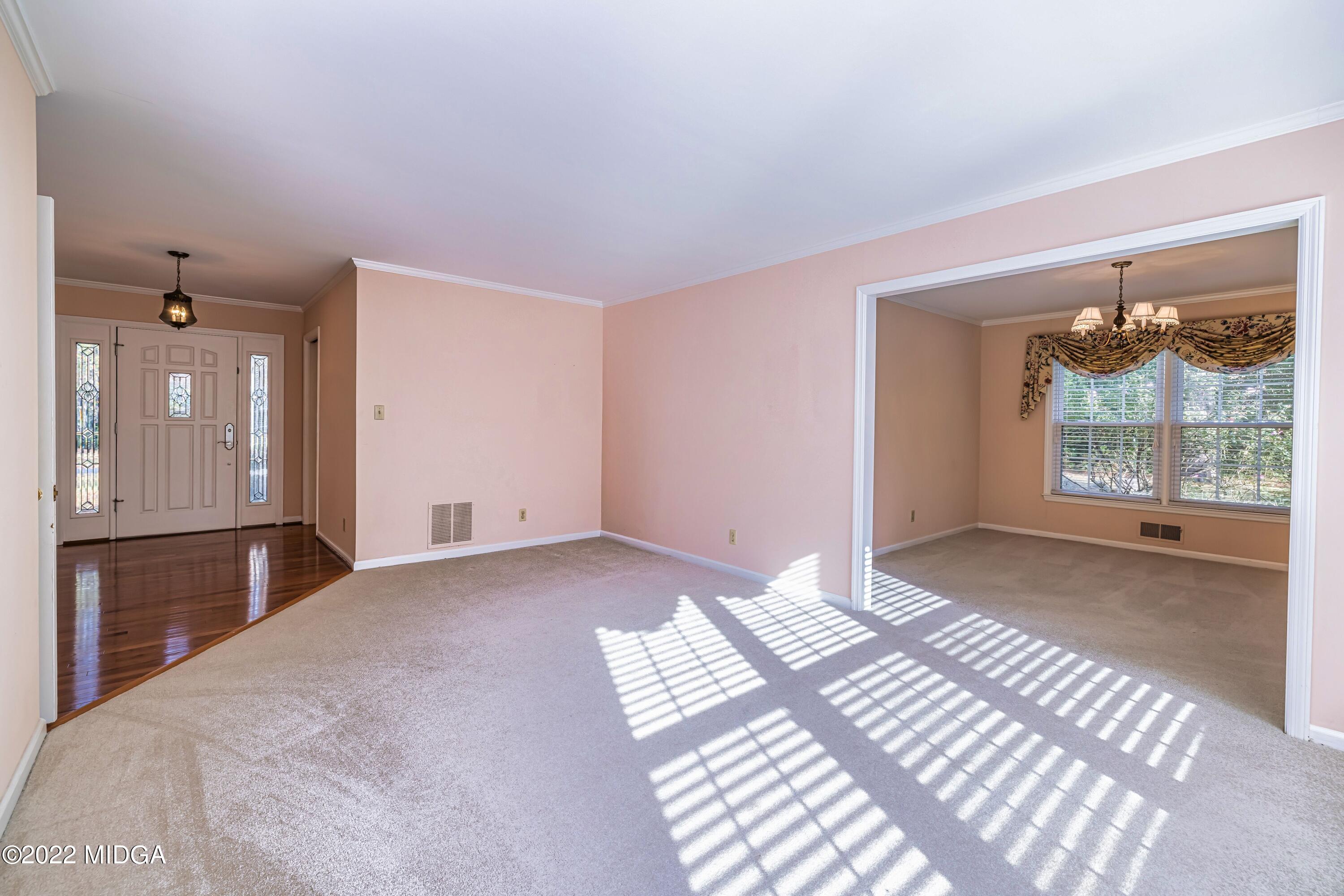 201 Larcom Lane Griffin, GA 30224 - Photo 16 of 64 a bedroom with a bed and a large window