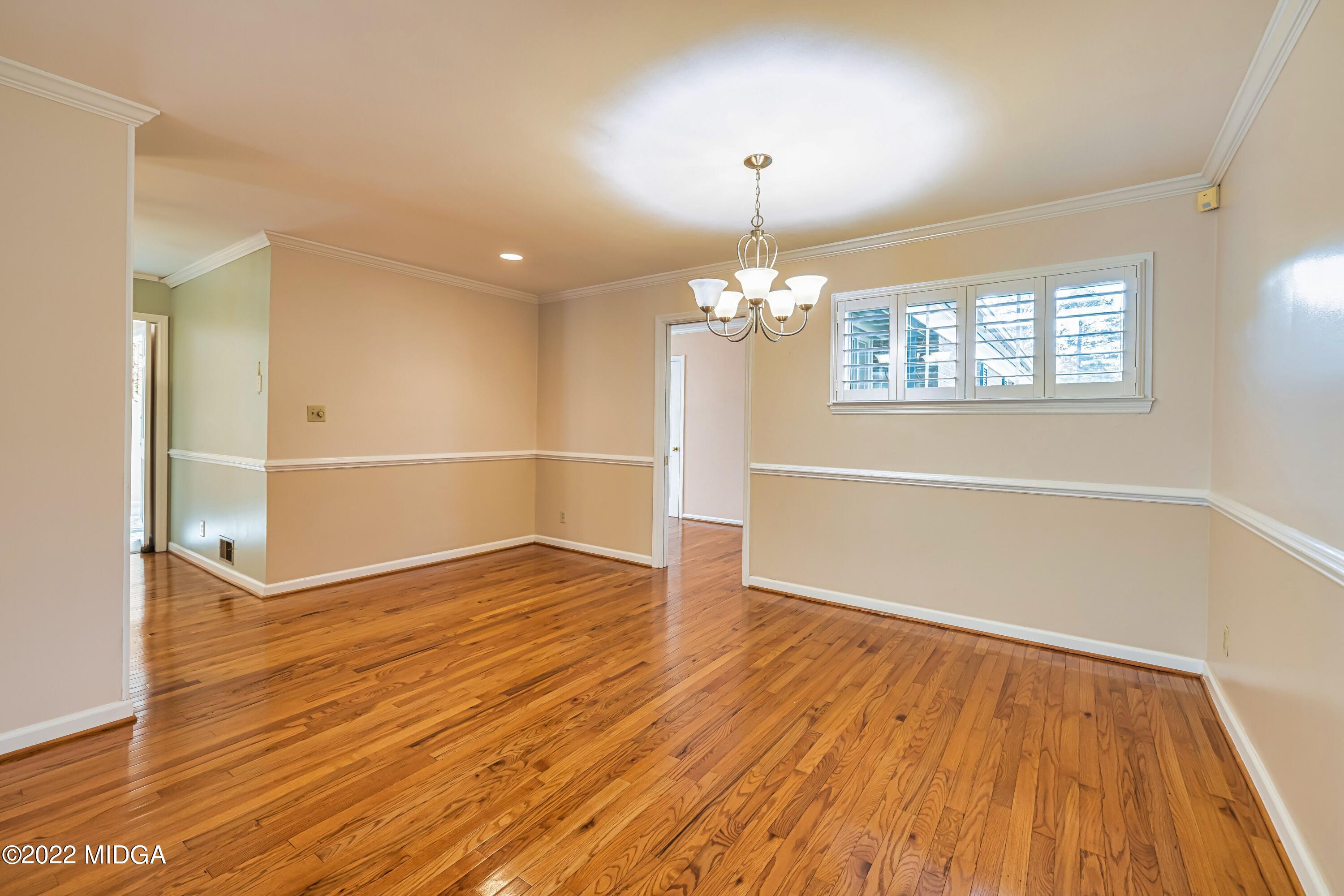 201 Larcom Lane Griffin, GA 30224 - Photo 21 of 64 wooden floor in an empty room with a window