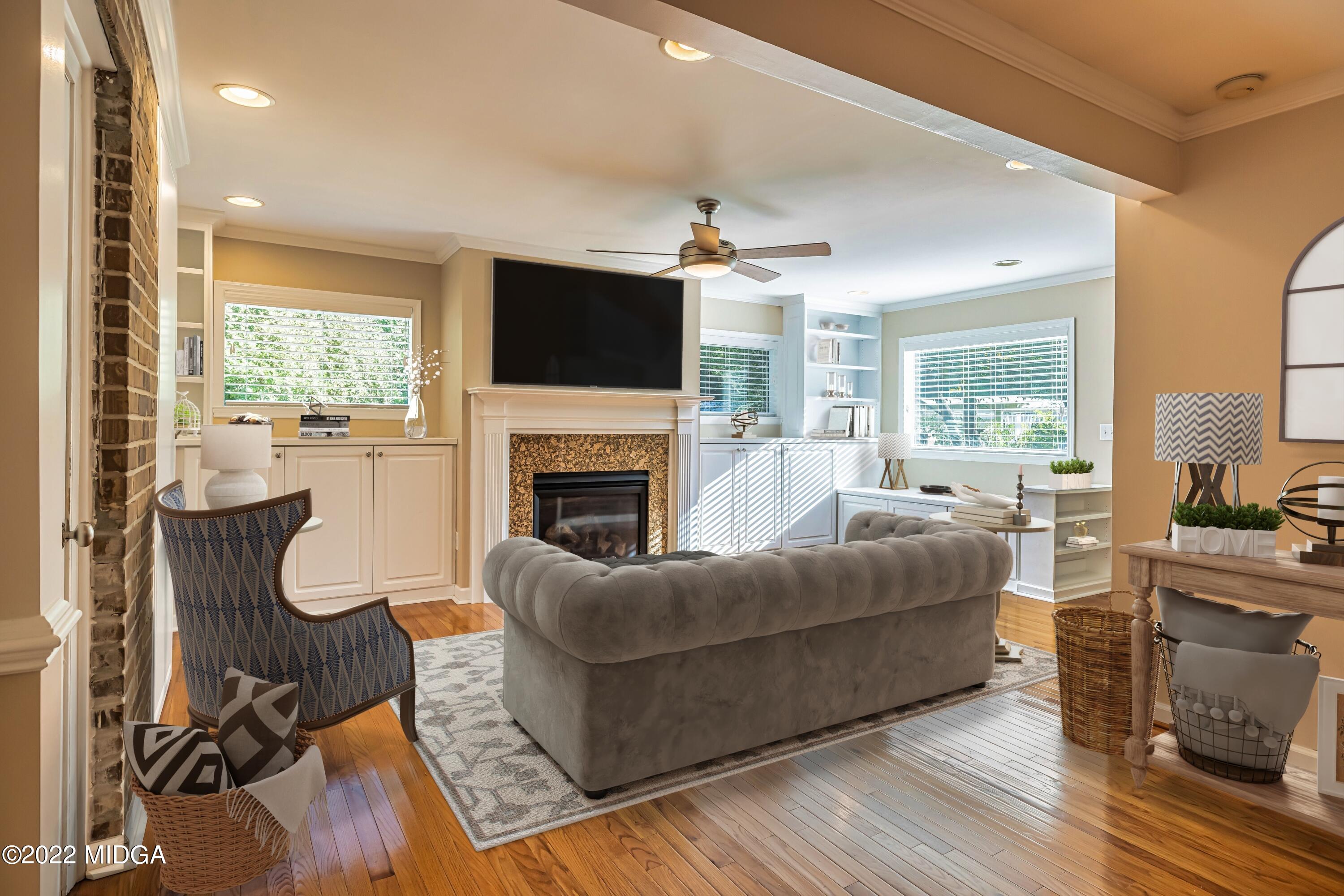 201 Larcom Lane Griffin, GA 30224 - Photo 24 of 64 a living room with furniture a flat screen tv and a fireplace
