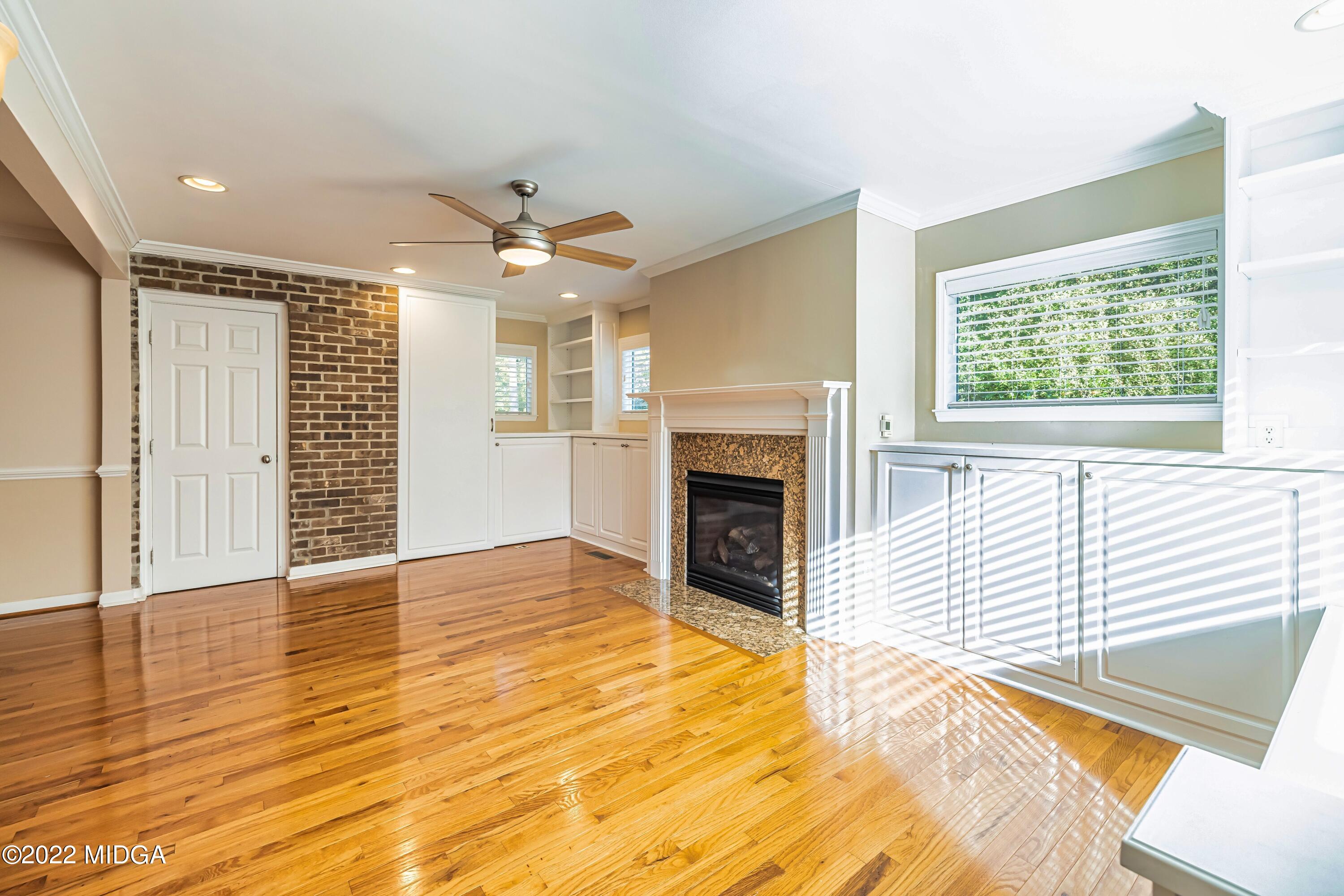 201 Larcom Lane Griffin, GA 30224 - Photo 26 of 64 a view of an empty room with a fireplace and a window