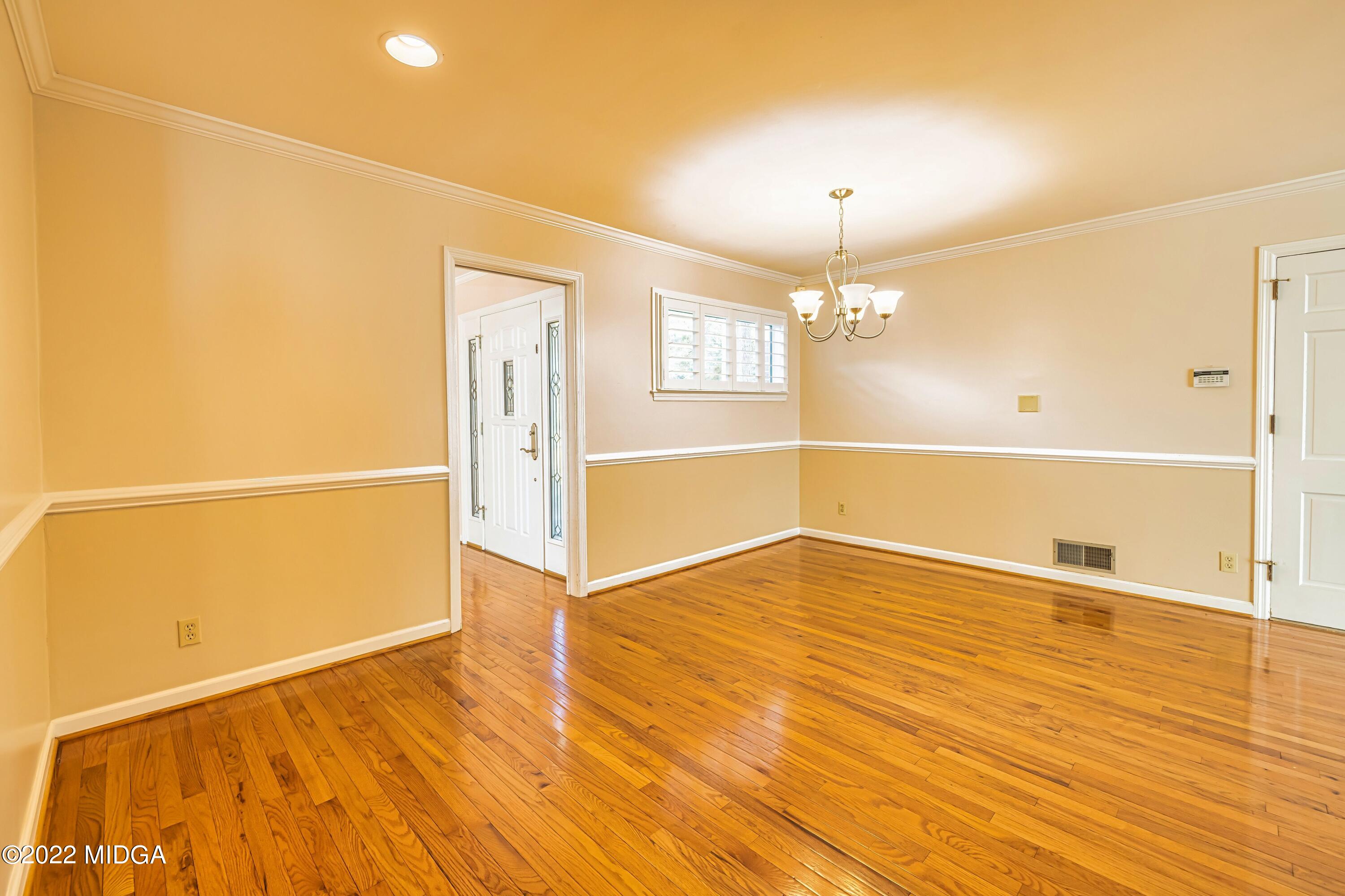 201 Larcom Lane Griffin, GA 30224 - Photo 29 of 64 a view of an empty room with wooden floor and a window