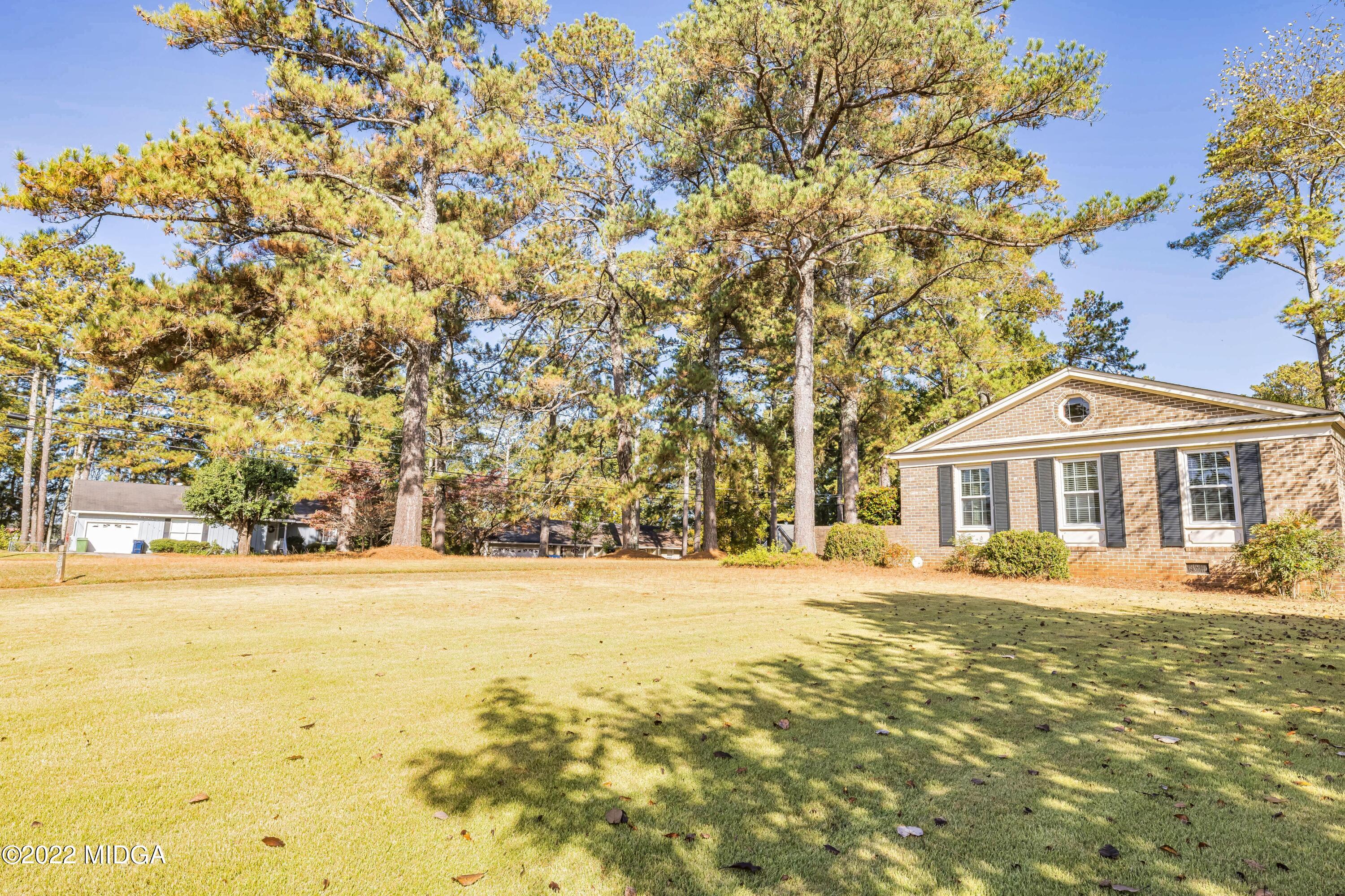 201 Larcom Lane Griffin, GA 30224 - Photo 3 of 64 a front view of a house with a yard and trees