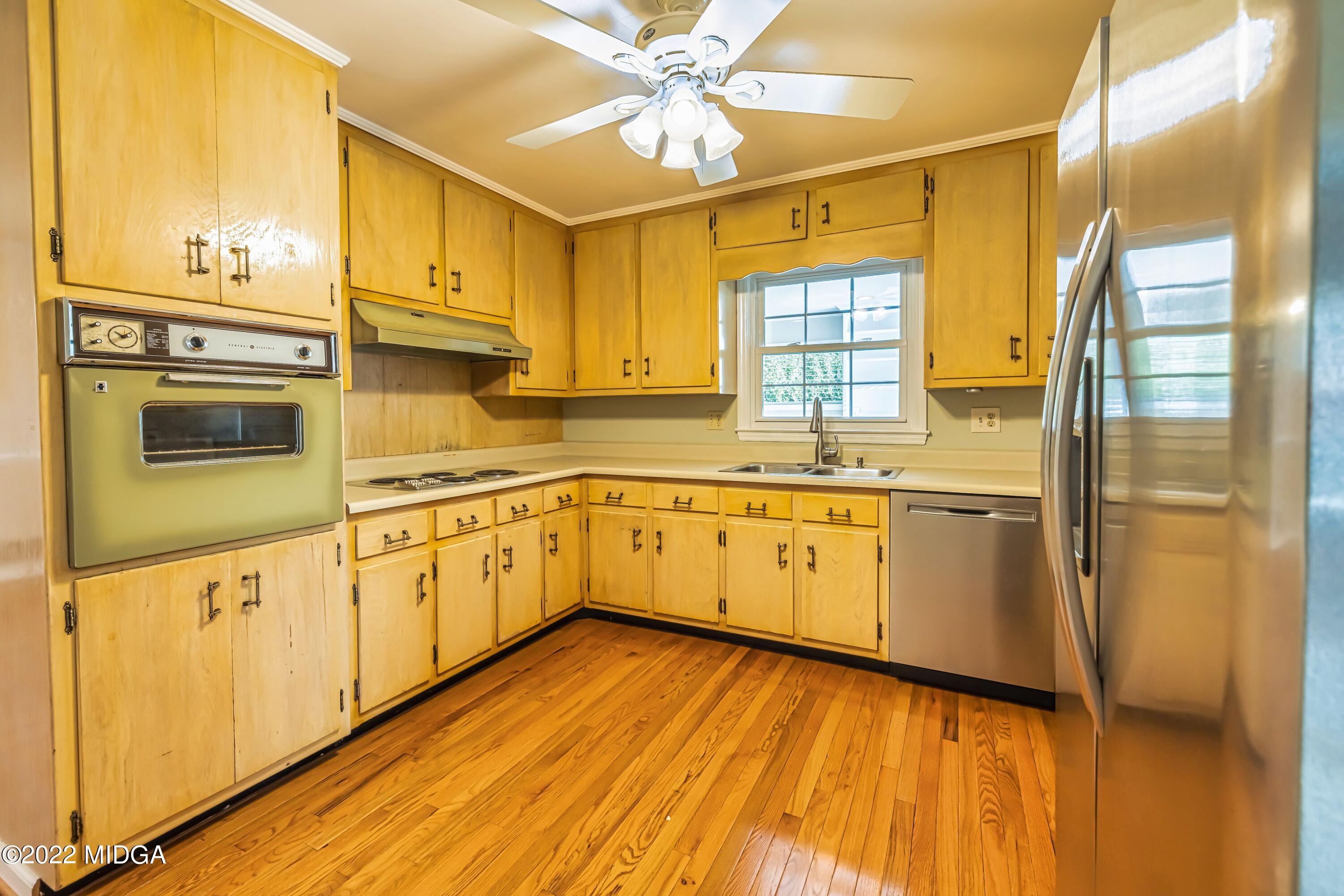 201 Larcom Lane Griffin, GA 30224 - Photo 31 of 64 a kitchen with a white cabinets and wooden floor