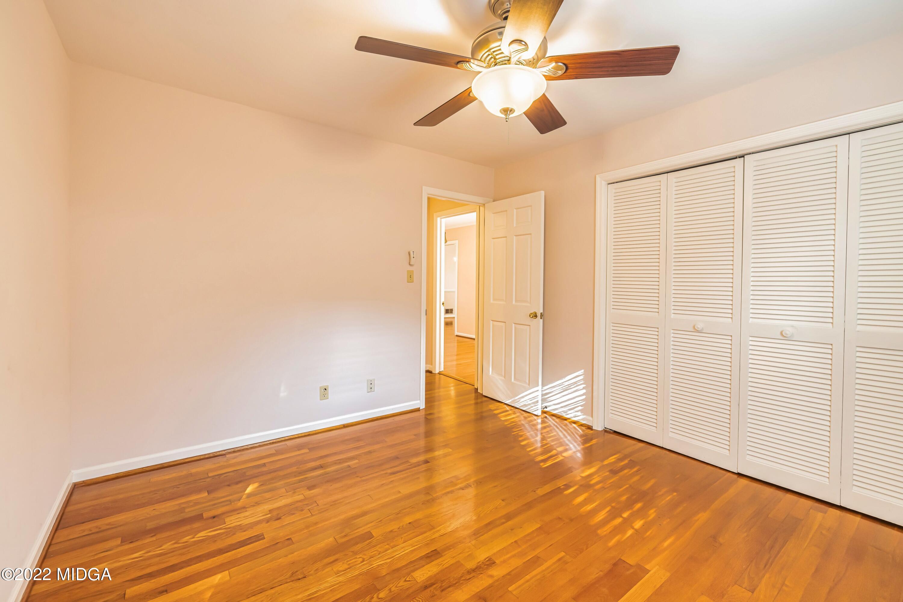 201 Larcom Lane Griffin, GA 30224 - Photo 34 of 64 an empty room with wooden floor fan and windows