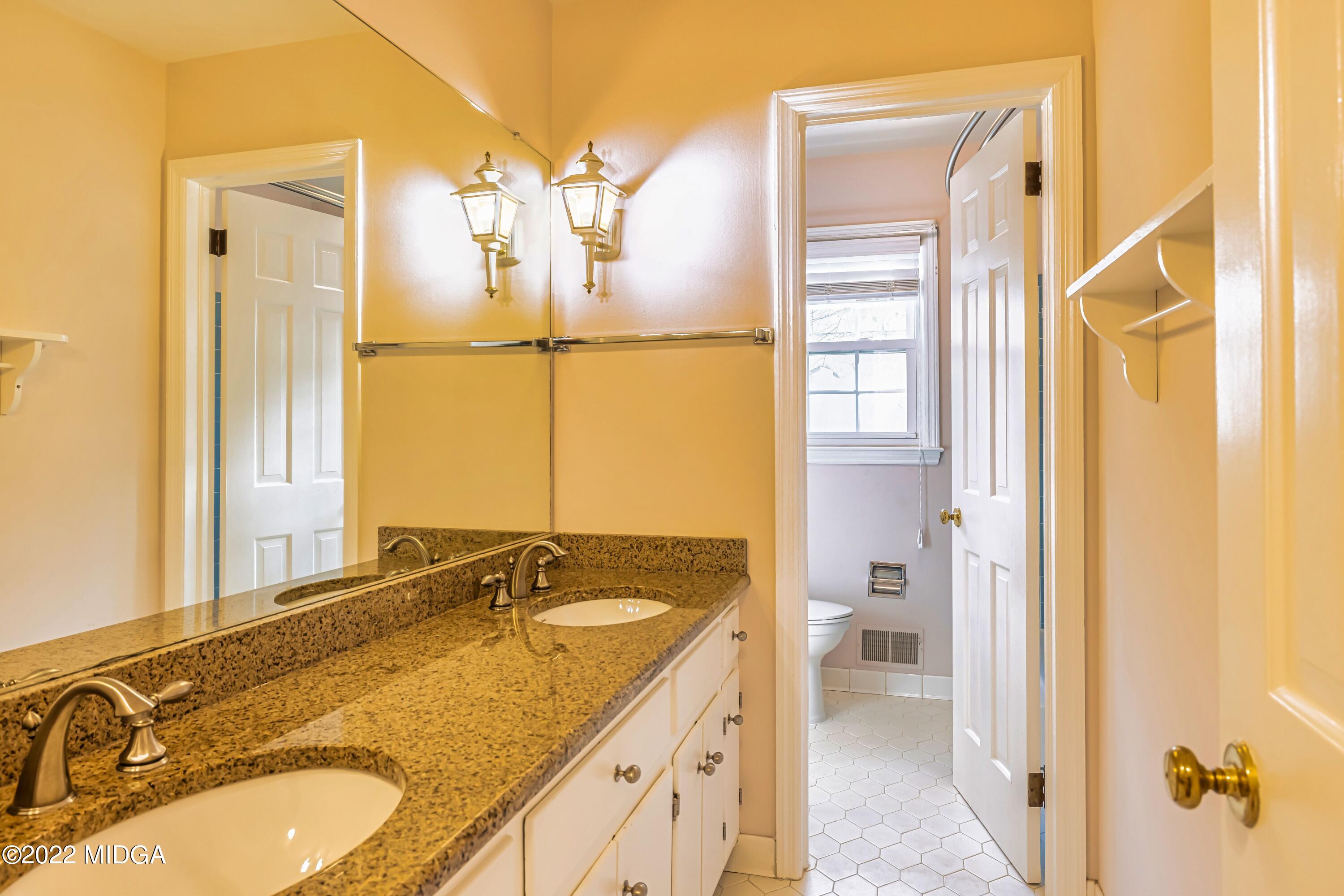 201 Larcom Lane Griffin, GA 30224 - Photo 36 of 64 a bathroom with a granite countertop sink and a mirror
