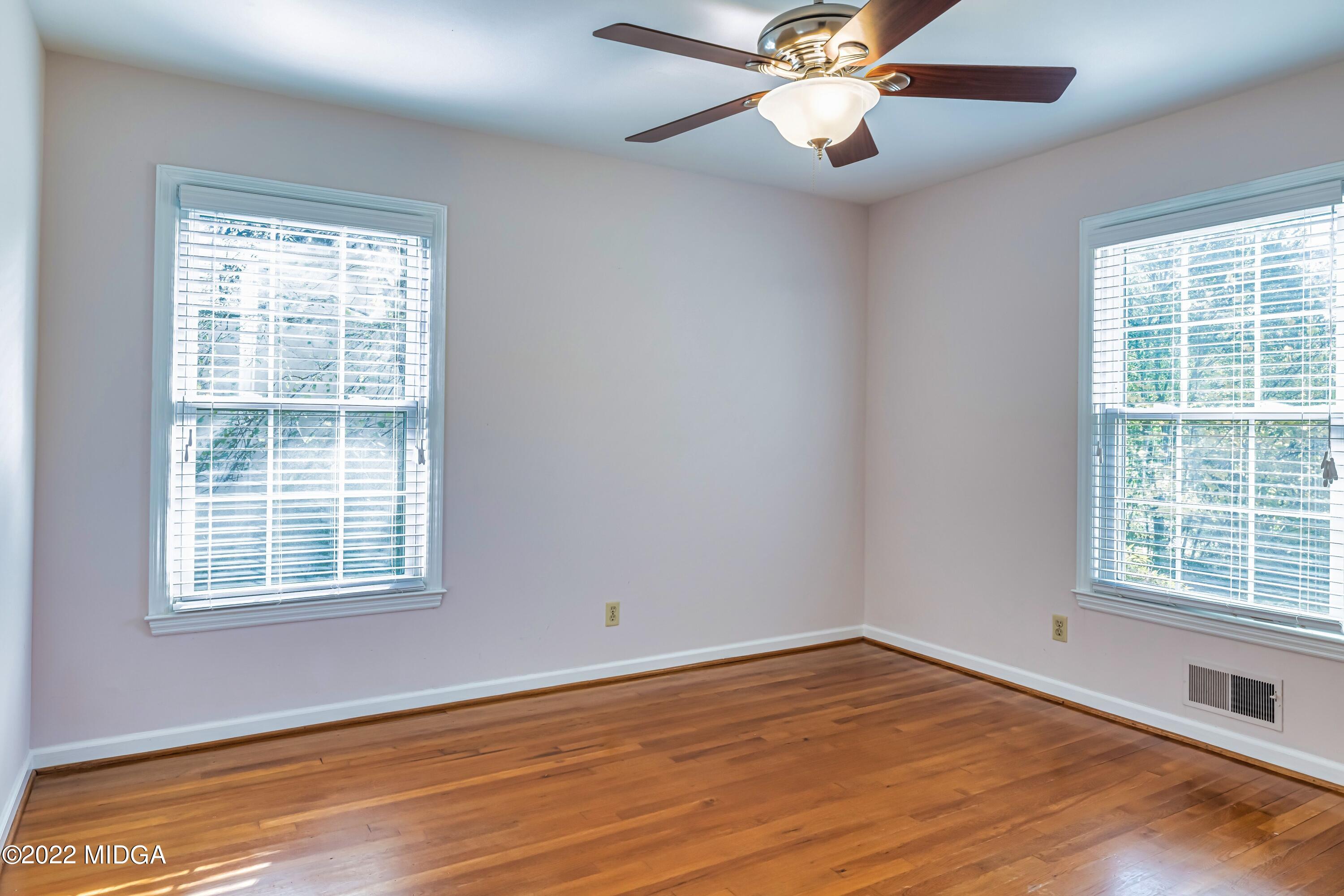 201 Larcom Lane Griffin, GA 30224 - Photo 37 of 64 a view of an empty room with wooden floor and a window