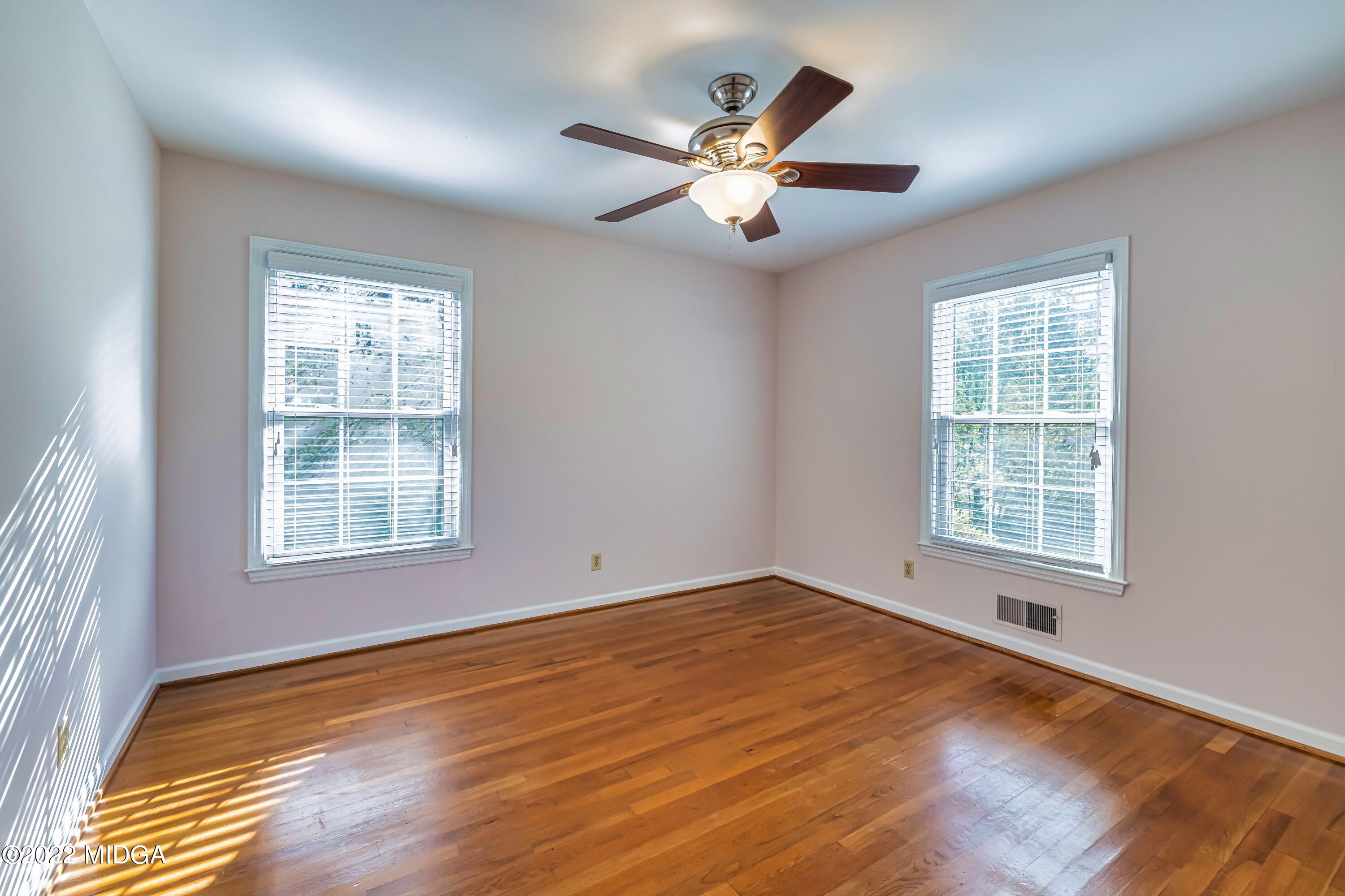 201 Larcom Lane Griffin, GA 30224 - Photo 39 of 64 a view of an empty room with wooden floor and a window