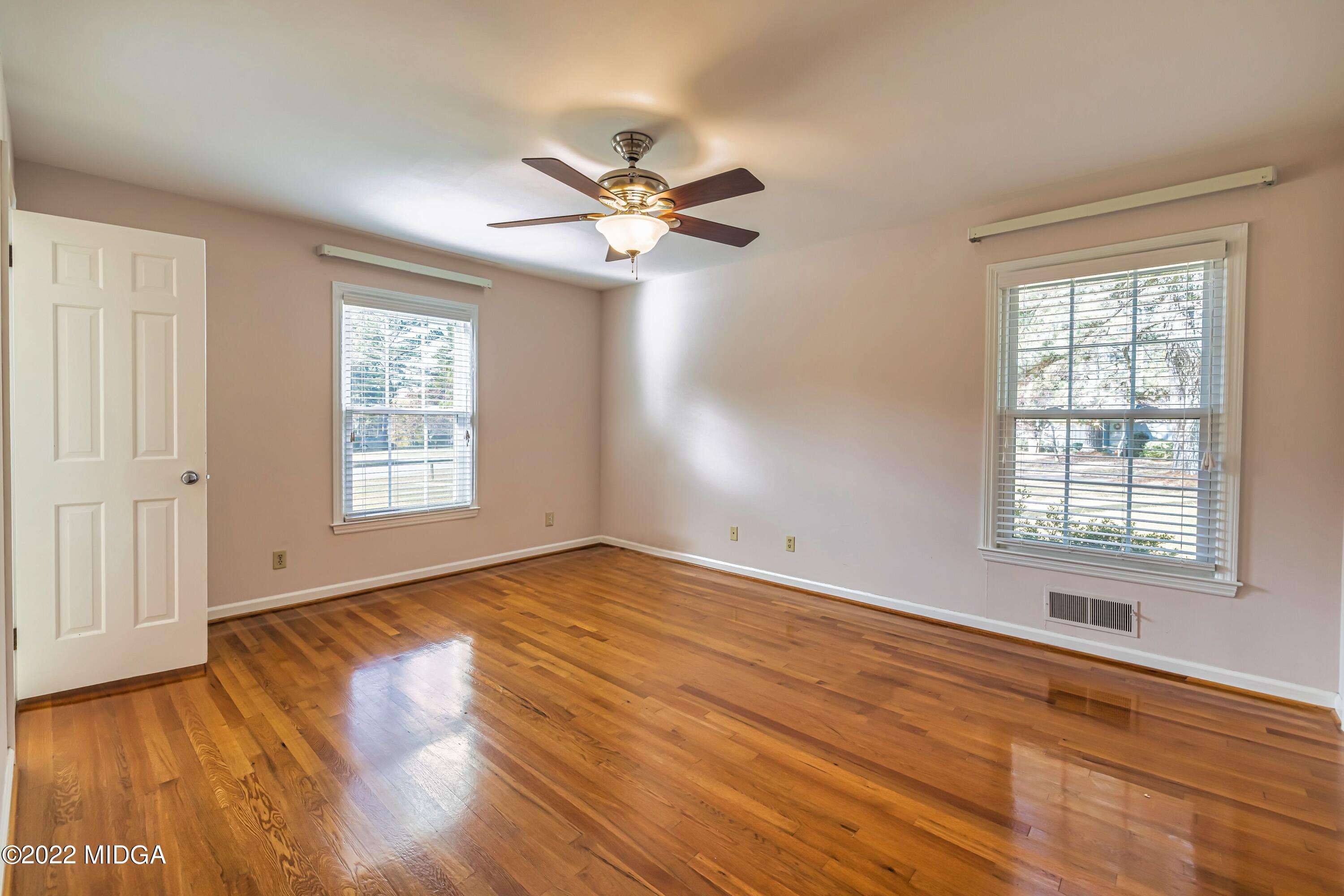 201 Larcom Lane Griffin, GA 30224 - Photo 40 of 64 a view of an empty room with wooden floor and a window