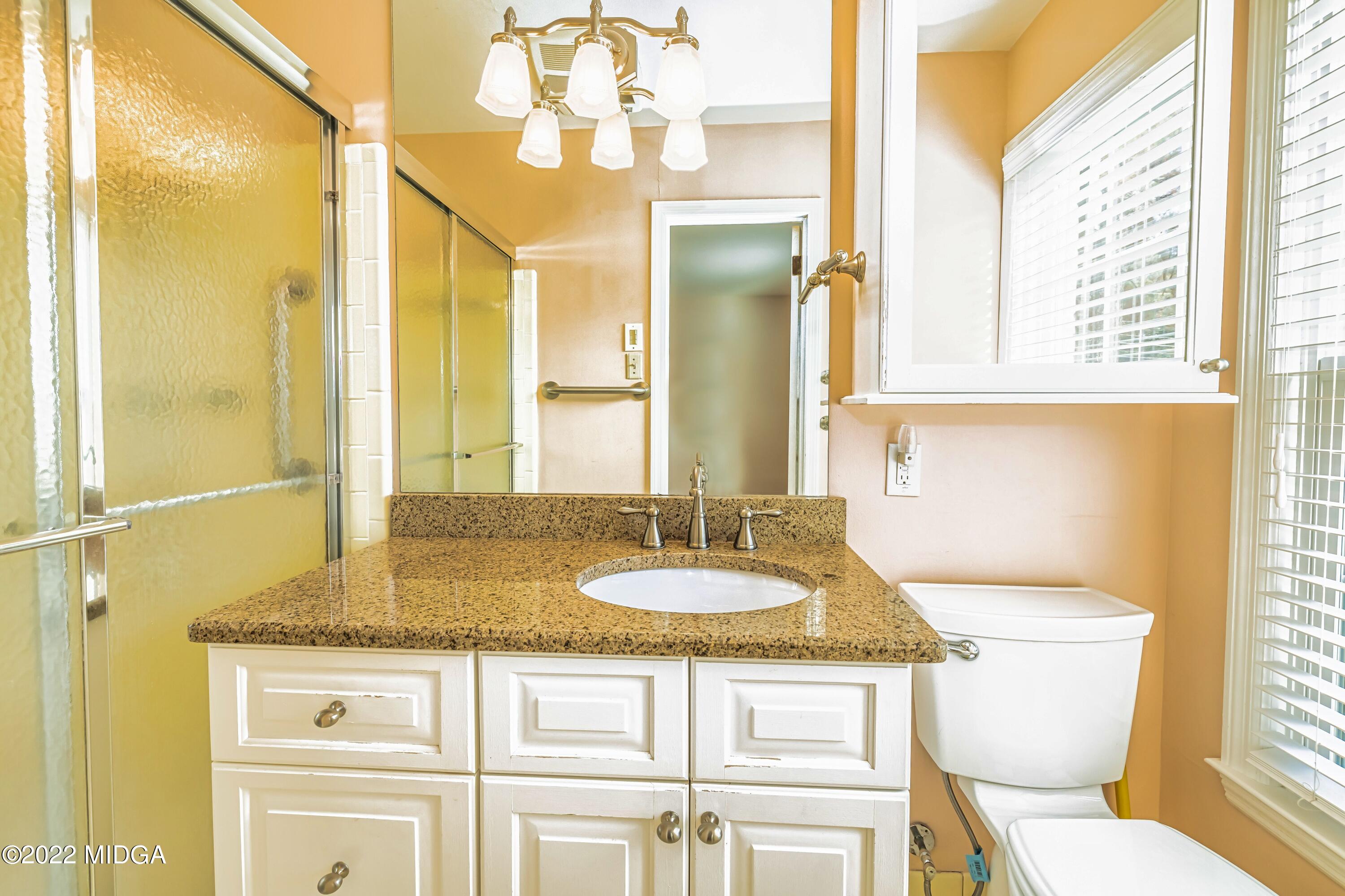 201 Larcom Lane Griffin, GA 30224 - Photo 44 of 64 a bathroom with a granite countertop sink and a mirror