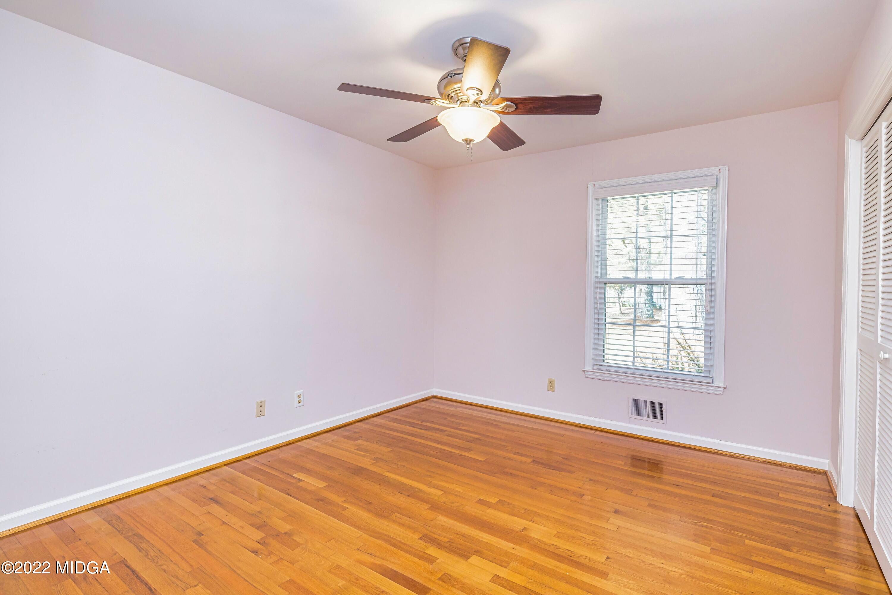 201 Larcom Lane Griffin, GA 30224 - Photo 45 of 64 wooden floor in an empty room with a window
