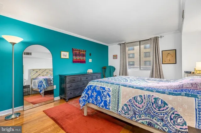 a bedroom with a bed and a dresser