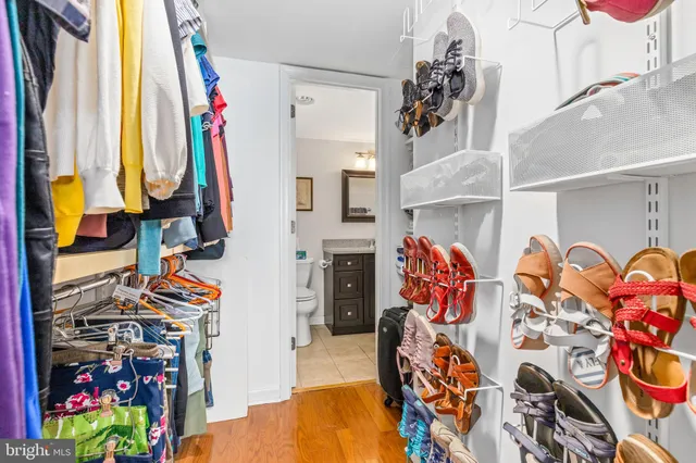 a view of walk in closet with clothes