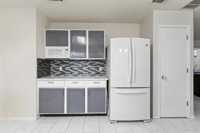 a kitchen with stainless steel appliances granite countertop a refrigerator and a stove