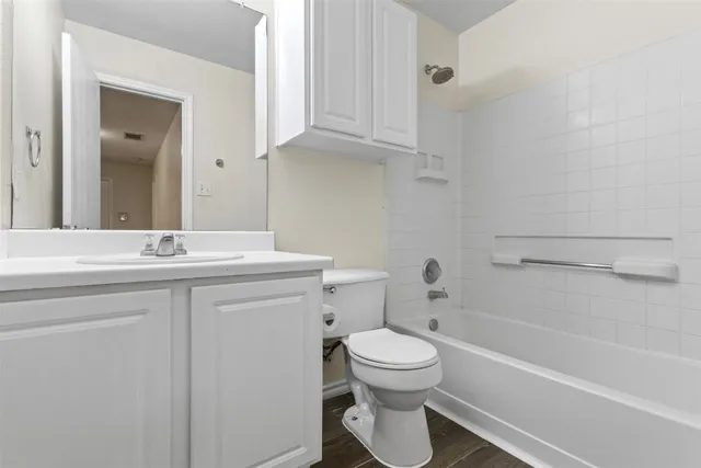 a bathroom with a sink a toilet and bathtub