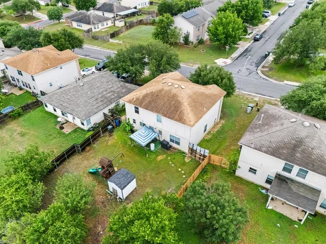 an aerial view of residential house with outdoor space and swimming pool