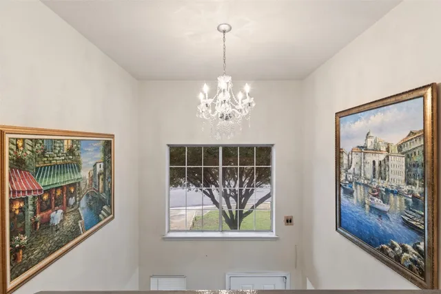 a view of a room with furniture large windows and wooden floor