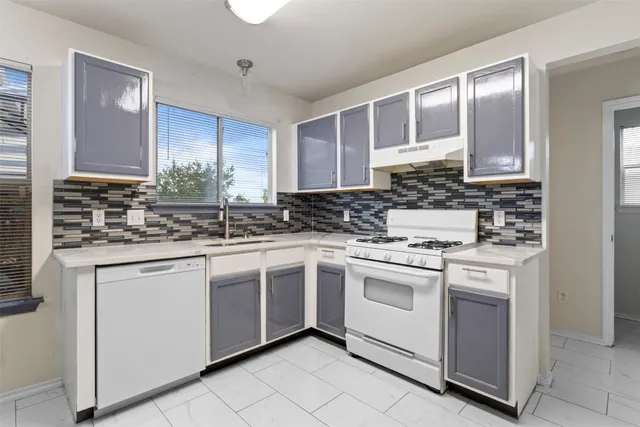 a kitchen with stainless steel appliances granite countertop a sink stove and cabinets