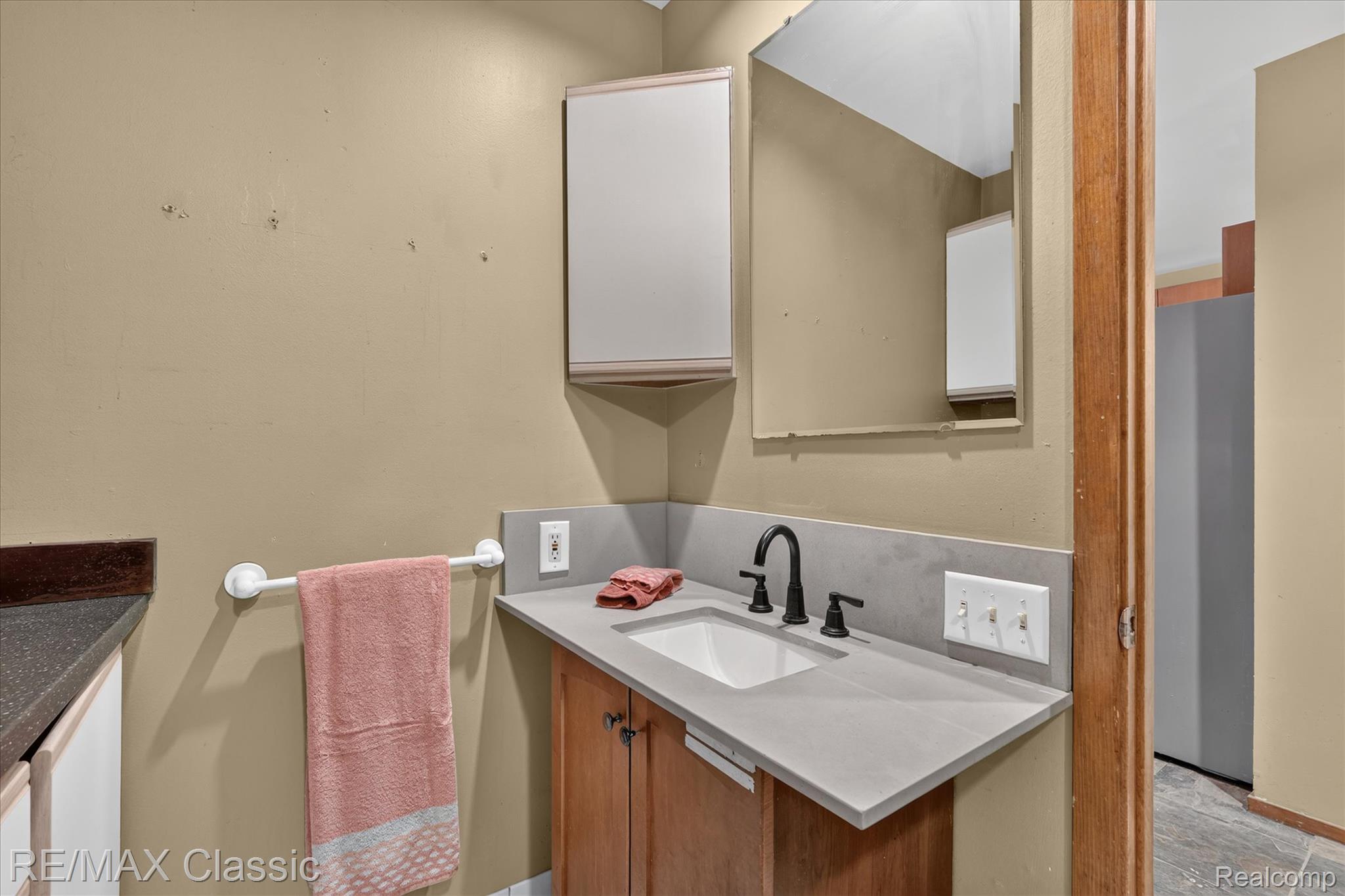 12189 Gage Road Holly, MI 48442 - Photo 49 of 69 Vanity with an integrated sink and a matte black faucet