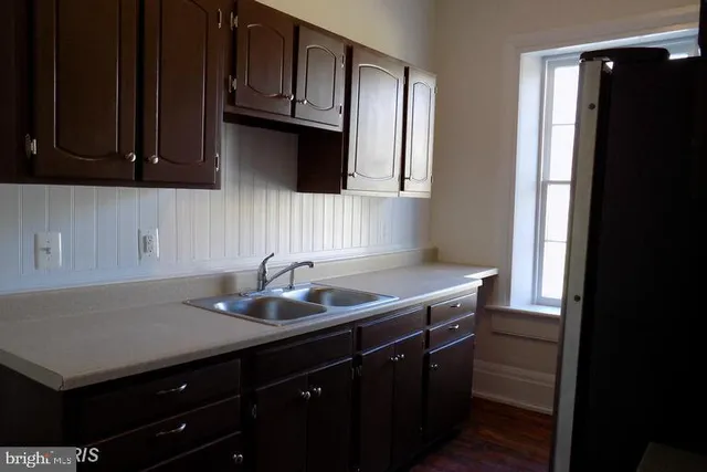 a kitchen with a refrigerator and window