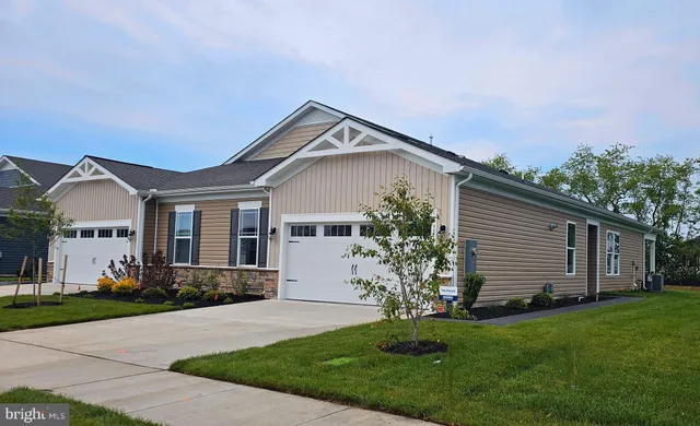 a front view of a house with a garden and plants