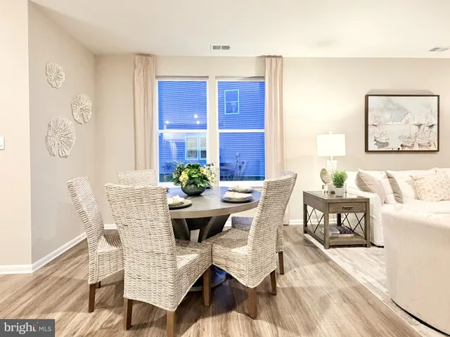 a view of a dining room with furniture and a potted plant