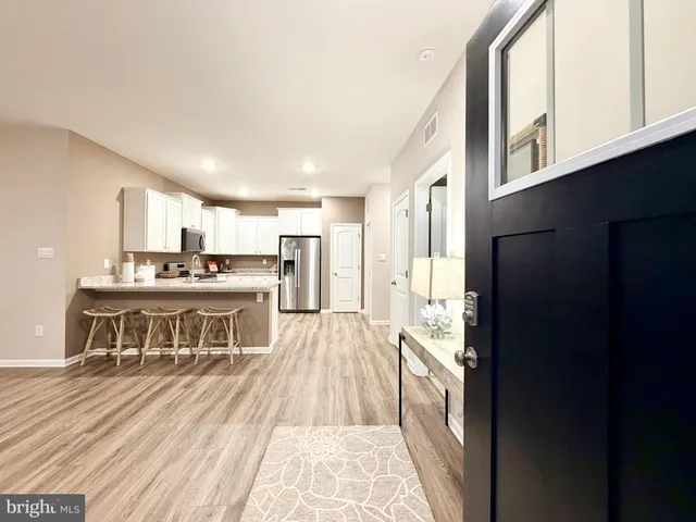 a kitchen with stainless steel appliances granite countertop a stove and a refrigerator