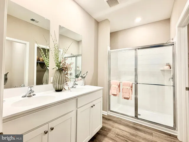 a bathroom with a double vanity sink mirror and