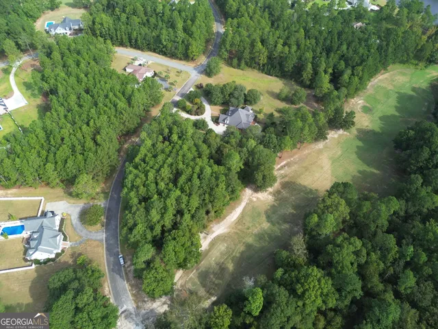 an aerial view of a house with a yard