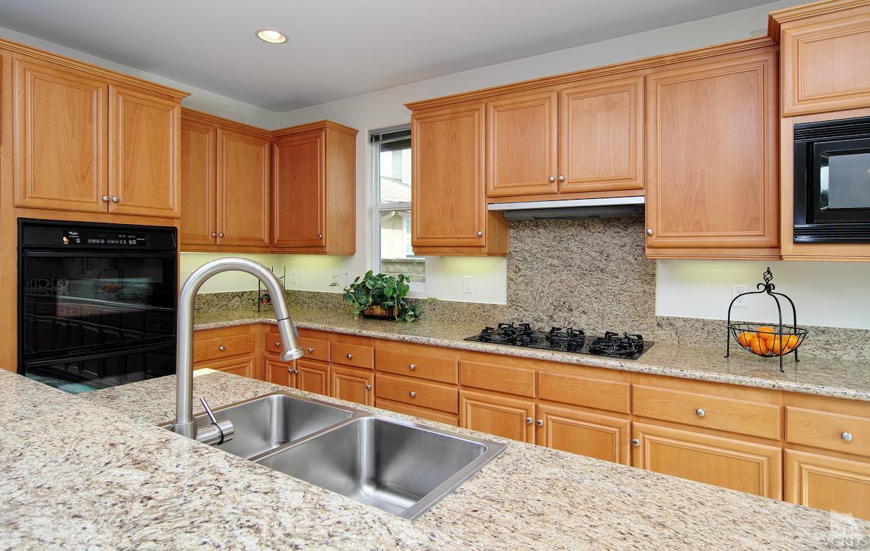 3522 Bridgehampton Way Camarillo, CA 93012 - Photo 11 of 52 a kitchen with granite countertop a sink stainless steel appliances and cabinets
