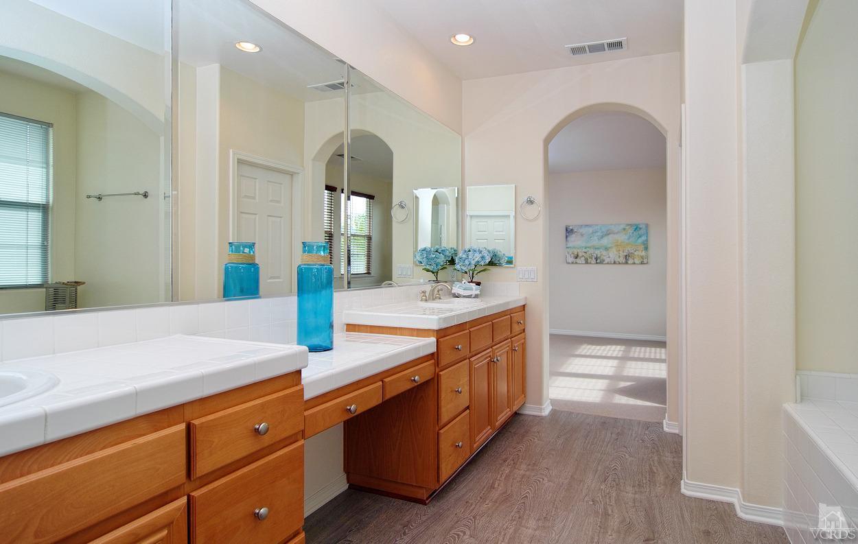3522 Bridgehampton Way Camarillo, CA 93012 - Photo 27 of 52 a spacious bathroom with a granite countertop sink and a mirror