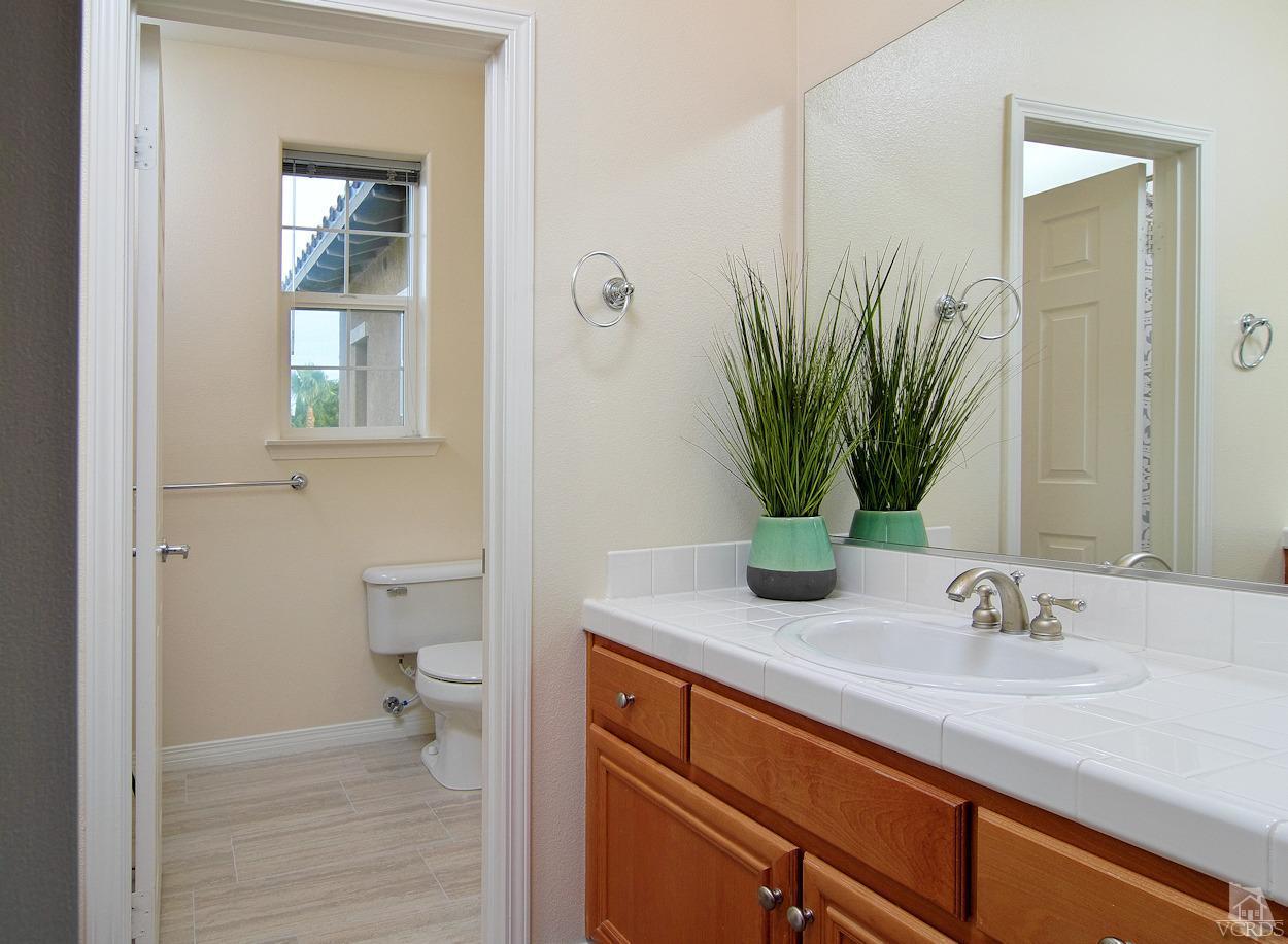 3522 Bridgehampton Way Camarillo, CA 93012 - Photo 31 of 52 a bathroom with a sink a toilet and mirror