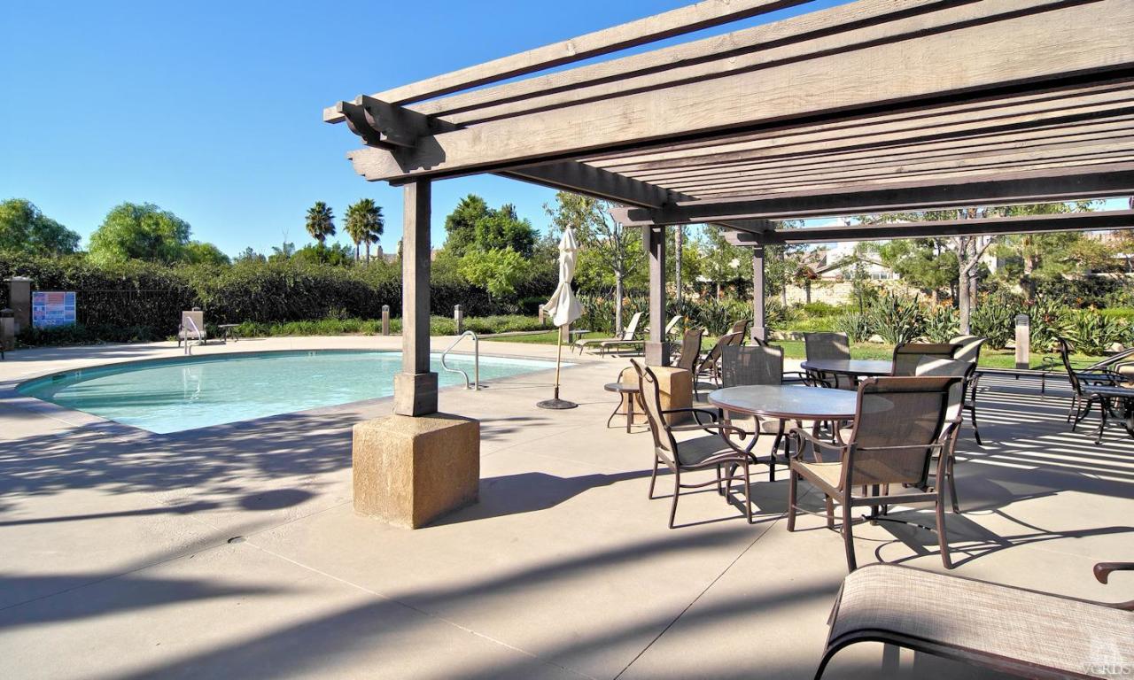 3522 Bridgehampton Way Camarillo, CA 93012 - Photo 43 of 52 a view of a swimming pool with a table and chairs in patio