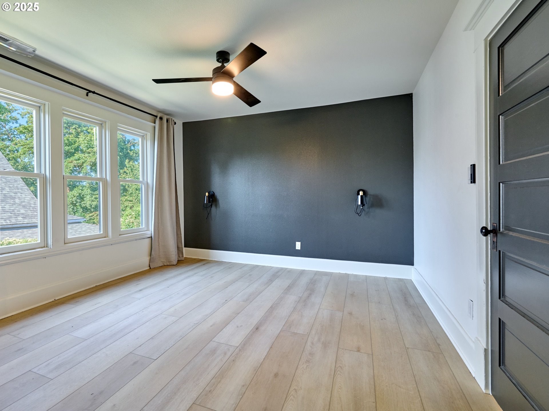 795 Corby Street Woodburn, OR 97071 - Photo 27 of 44 a view of an empty room with wooden floor and a window