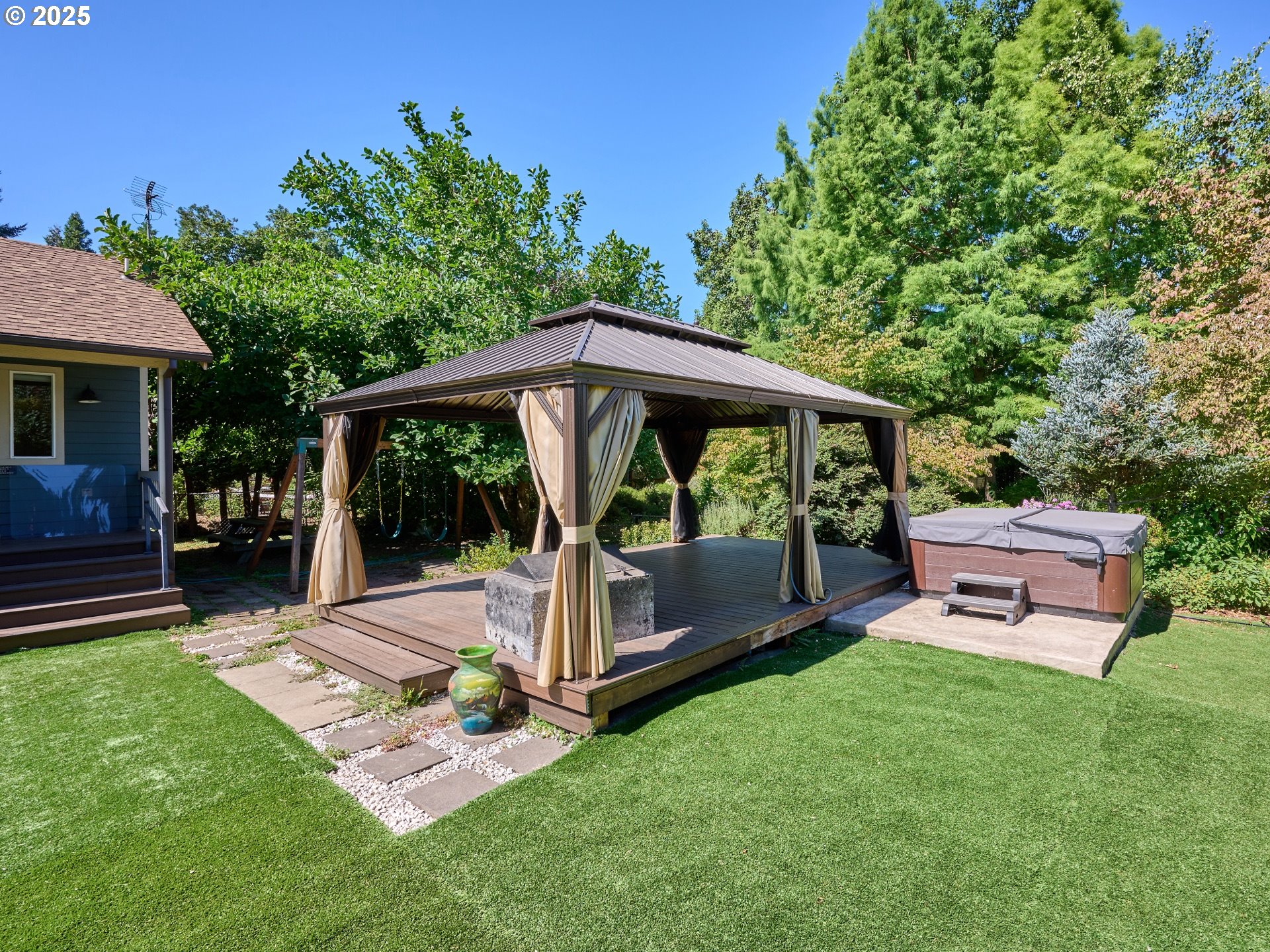 795 Corby Street Woodburn, OR 97071 - Photo 33 of 44 a view of a patio with table and chairs potted plants and large tree