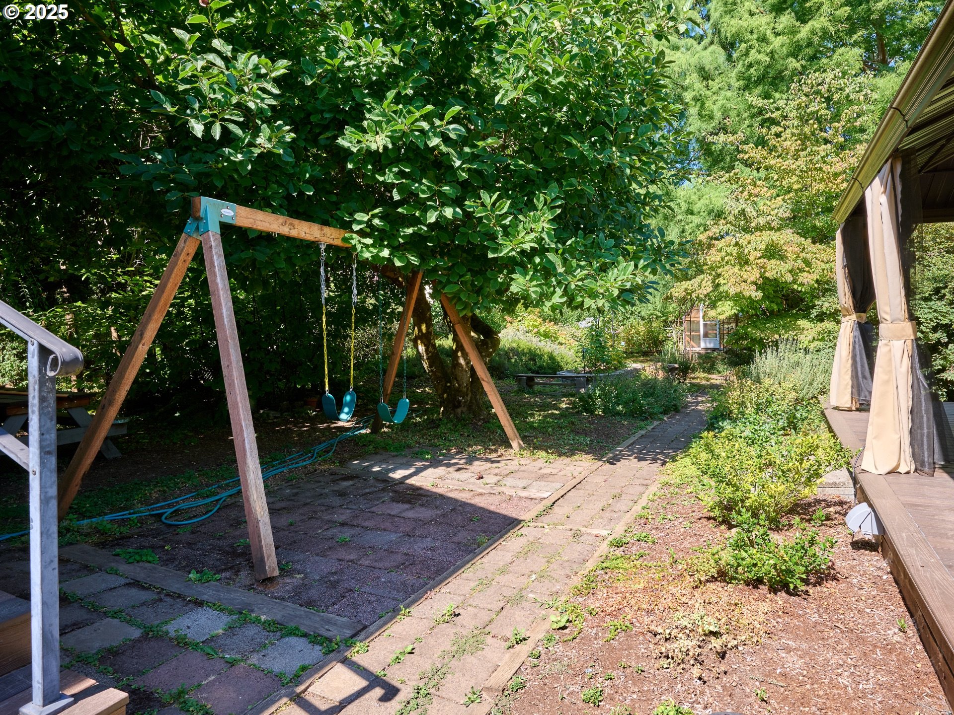 795 Corby Street Woodburn, OR 97071 - Photo 37 of 44 a backyard of a house with lots of plants and entertaining space