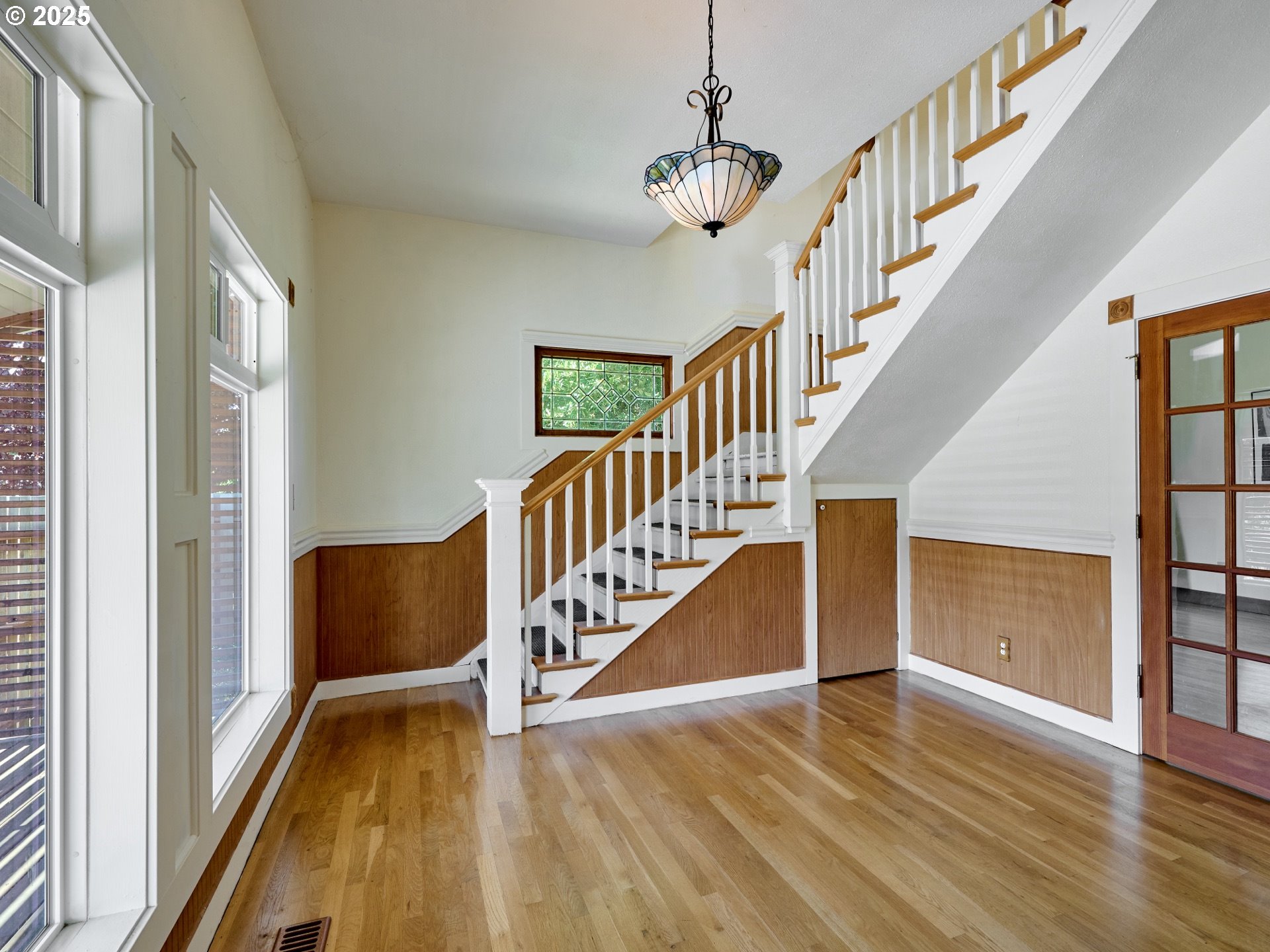 795 Corby Street Woodburn, OR 97071 - Photo 4 of 44 a view of staircase with wooden floor and white walls